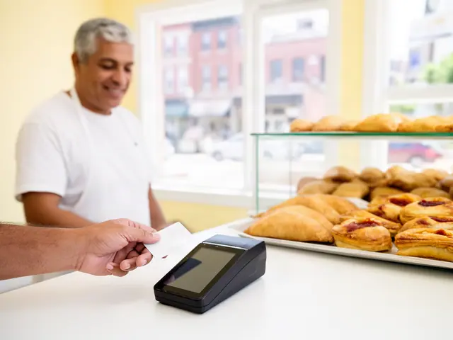 A customer taps a card on a counter terminal at a small Puerto Rican bakery.